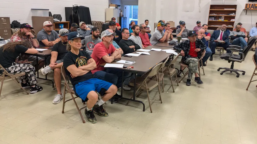 Workers listened carefully to Chairman Adam Rondon before the vote