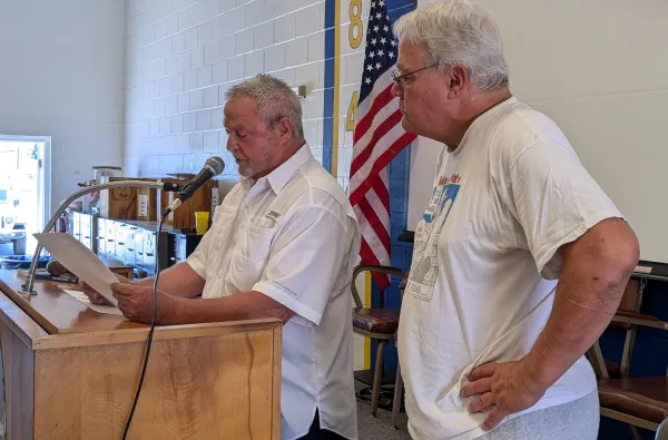 David Barker reads the oath while Gary Tessmar looks on